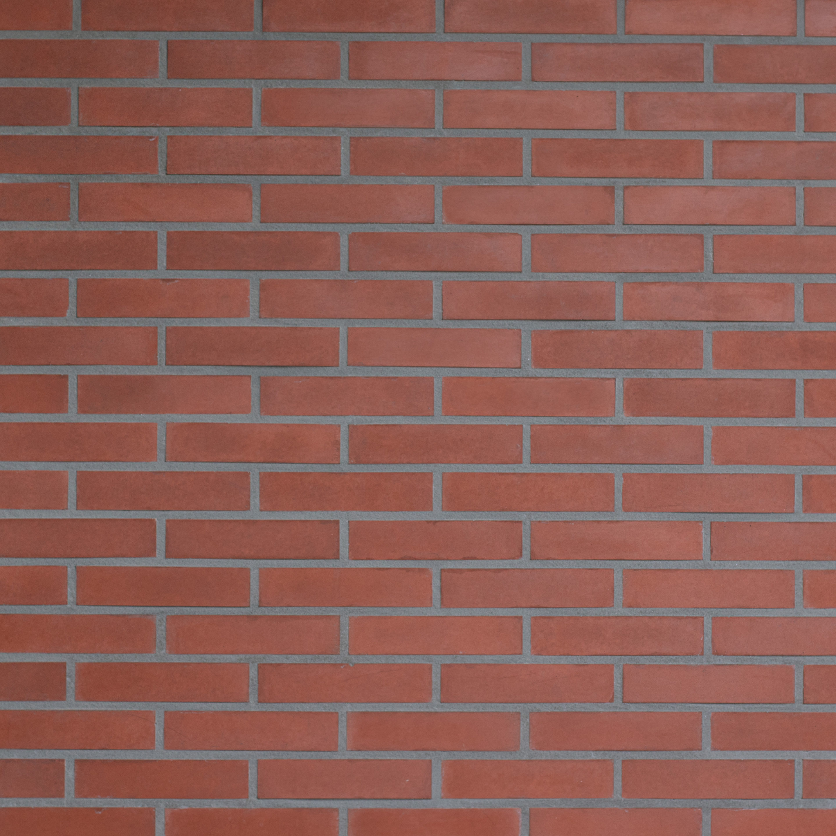 Parement mural en Brique Chromatik rouge antique, briquette reconstituée à texture lisse posée en panneresse – produit Matiera Orsol vendu par Orpa Matériaux (Elaustore).
